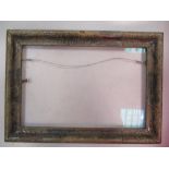 An English 19th Century silvered moulding frame, carved in the gesso at the corners, sight size 21 x