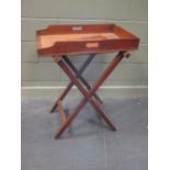 A mahogany butlers tray with folding stand