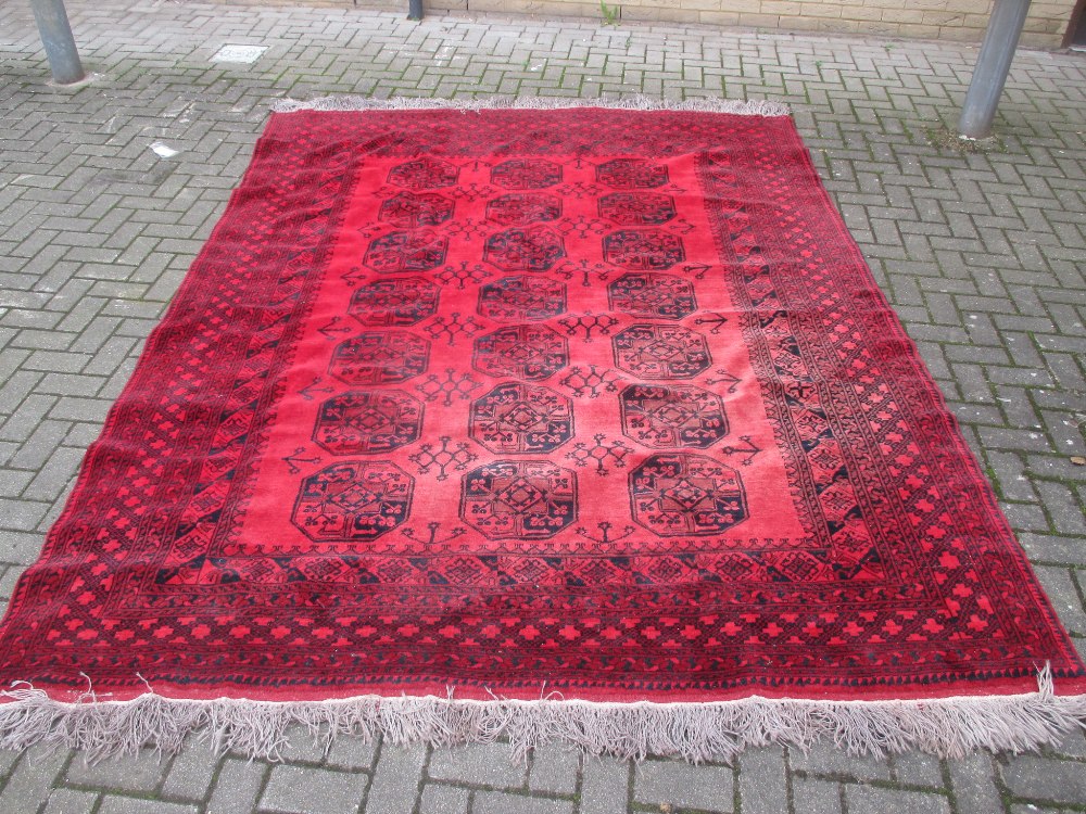 A red ground Afghan type rug 330 x 238cm