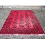 A red ground Afghan type rug 330 x 238cm