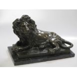 After Barye, bronze figure of a recumbant lion on marble base, 29cm long overall