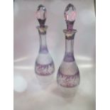 A pair of amethyst flash overlay cut glass decanters of slender form, with silver collars, hallmarks
