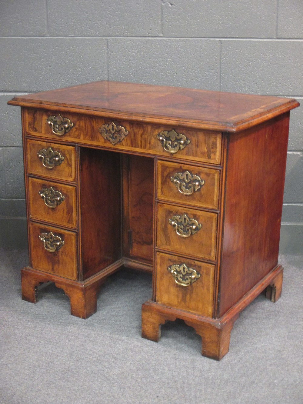 An 18th century walnut kneehole desk on bracket feet 75 x 83 x 53cm