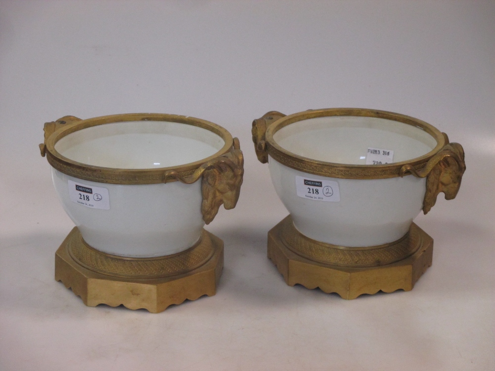 A pair of modern Czechoslavakian white porcelain and ormolu mounted vases with Rams Head handles,
