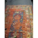 A worn red ground rug 162 x 95 (A/F)