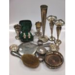A collection of silverware including five vases, a bottle coaster, pin trays, toastrack cased pair