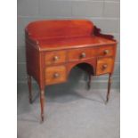 A Regency mahogany Gentleman's dressing stand with galleried back, drawers and on turned legs and