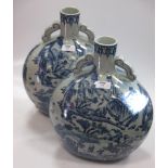 A pair of Oriental blue and white moon flasks (2)