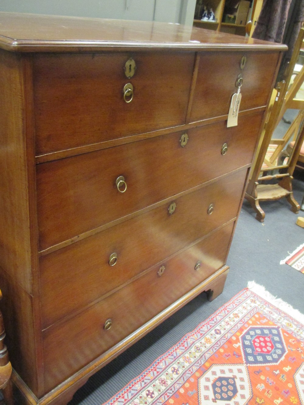 A George III red walnut chest of drawers - alterations