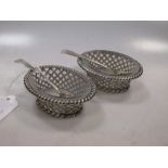 A pair of Victorian silver oval shaped table salts, the sides of basket weave appearance, with