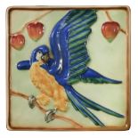 A Goldscheider Pottery plaque depicting a Parrot, the square plaque painted in colours, printed