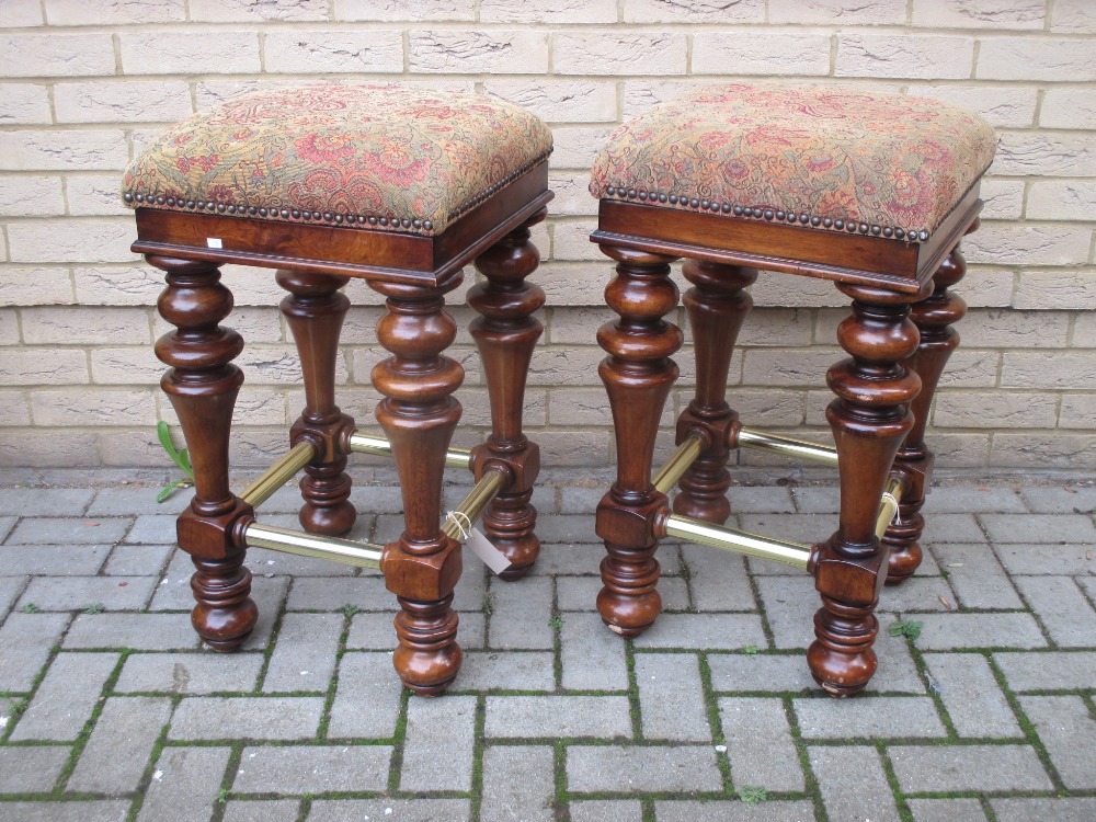 A pair of turned wood and brass mounted heavy bar stools