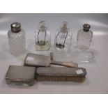 Two dressing table jars with silver tops, together with a silver backed hair and clothes brush,