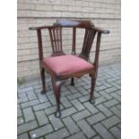 A George III mahogany corner armchair,