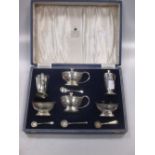 A cased six piece silver condiment set by Garrard & Co with non matching spoons 8.8ozt