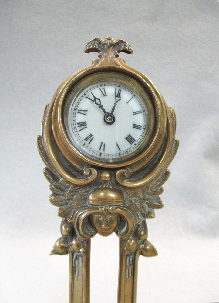 An Art Nouveau brass desk clock by the British United Clock Co., the enamelled dial above a female - Image 2 of 3