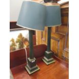 A pair of green and gilt wooden column lamps with shades and a pair of painted plaster classical