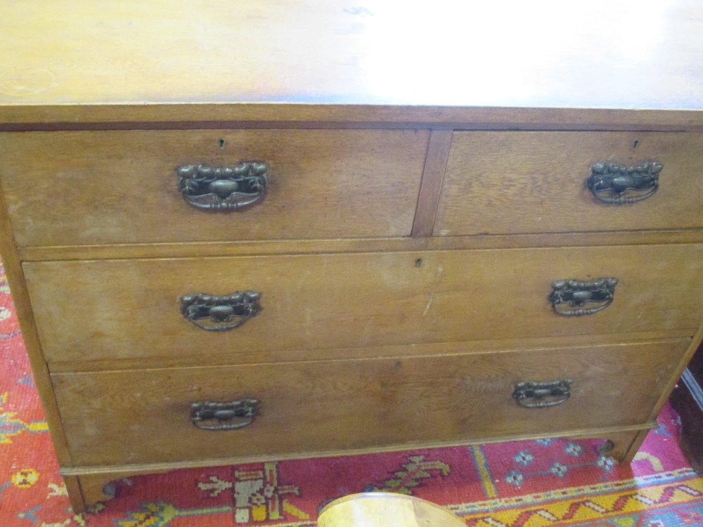 An Art Nouveau ash chest of drawers 122cm wide