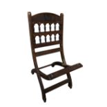 An Aesthetic period folding chair, the design attributed to Bruce Talbot, with carved, pierced and
