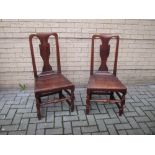 A pair of 18th century elm panel seat chairs with joint supports (2)