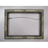 An Italian 19th Century polychrome moulding frame with leaf decoration to corners, sight size 19 x