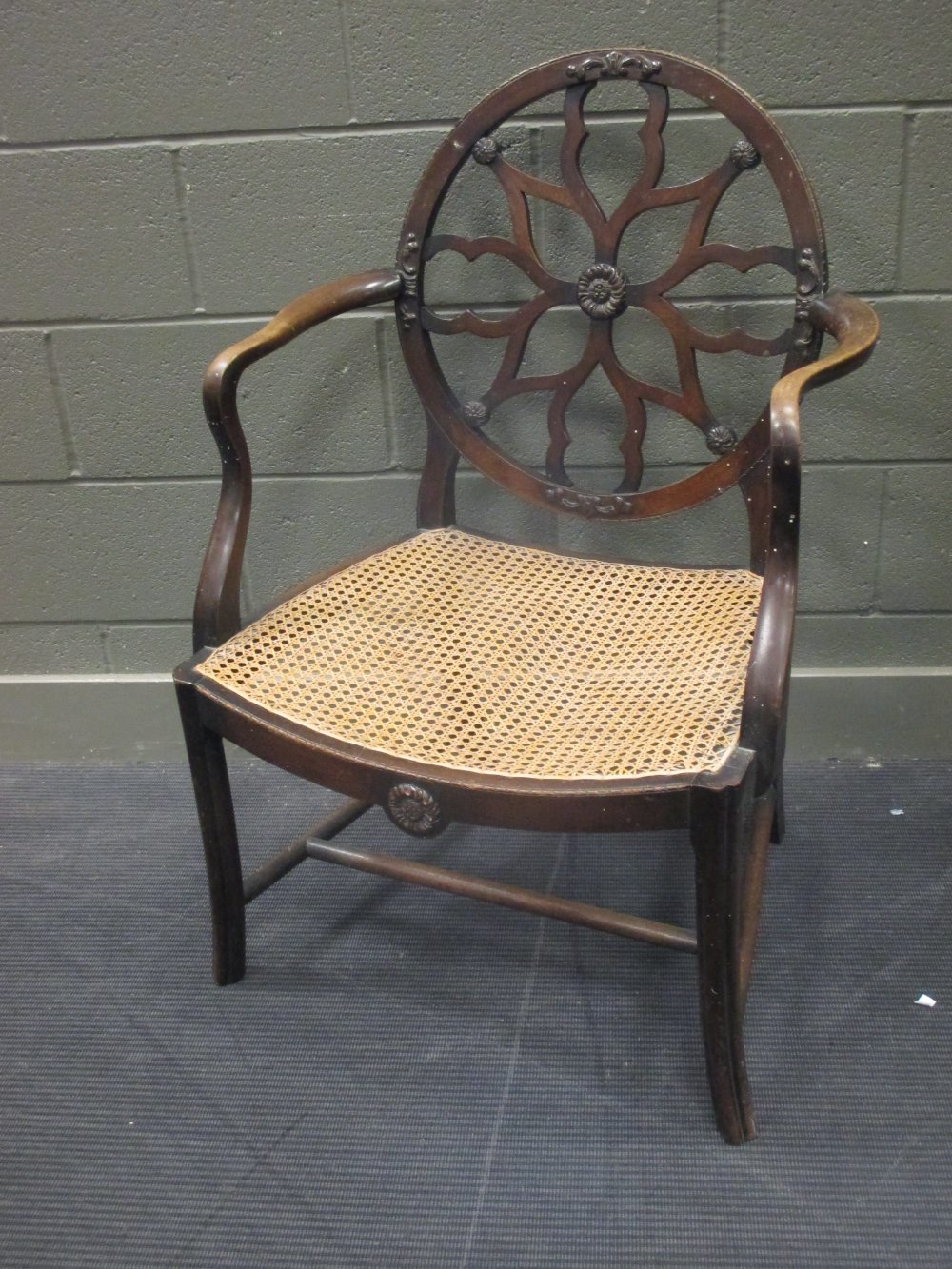 An Edwardian armchair with caned seat