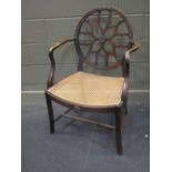 An Edwardian armchair with caned seat