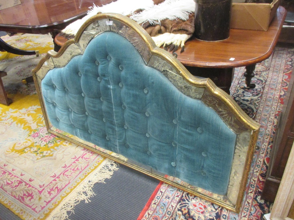 A padded headboard with mirrored panel border 145cm wide