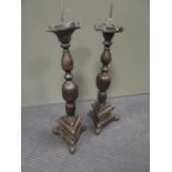 A pair of wooden altar candle sticks (2)