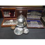A plated meat cover, shell dish and two canteens of mother of pearl and bone handled cutlery