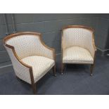 A pair of Edwardian finely upholstered "tub" chairs