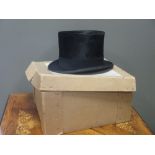 A leather cased top hat and one other hat (2)