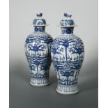 A pair of Chinese blue and white export porcelain baluster vases and covers, Qing Dynasty, circa