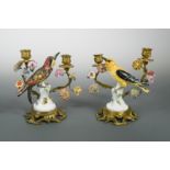 A pair of German porcelain and ormolu mounted two-branch candlesticks,