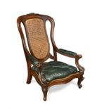 An early Victorian library armchair with green leather squab seat,