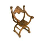 A late 19th century Syrian X framed armchair,