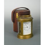 A late Victorian oval brass repeating carriage clock,