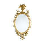 A pair of George III oval gilt framed mirrors,