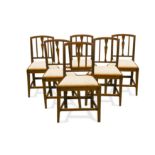 A set of six late George III Sheraton yew wood dining chairs,