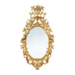 A pair of mid 19th century oval gilt framed wall mirrors,