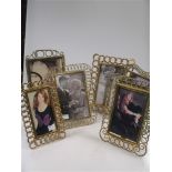 Four decorative brass photograph frames, late Victorian and Edwardian, and two other gilt metal