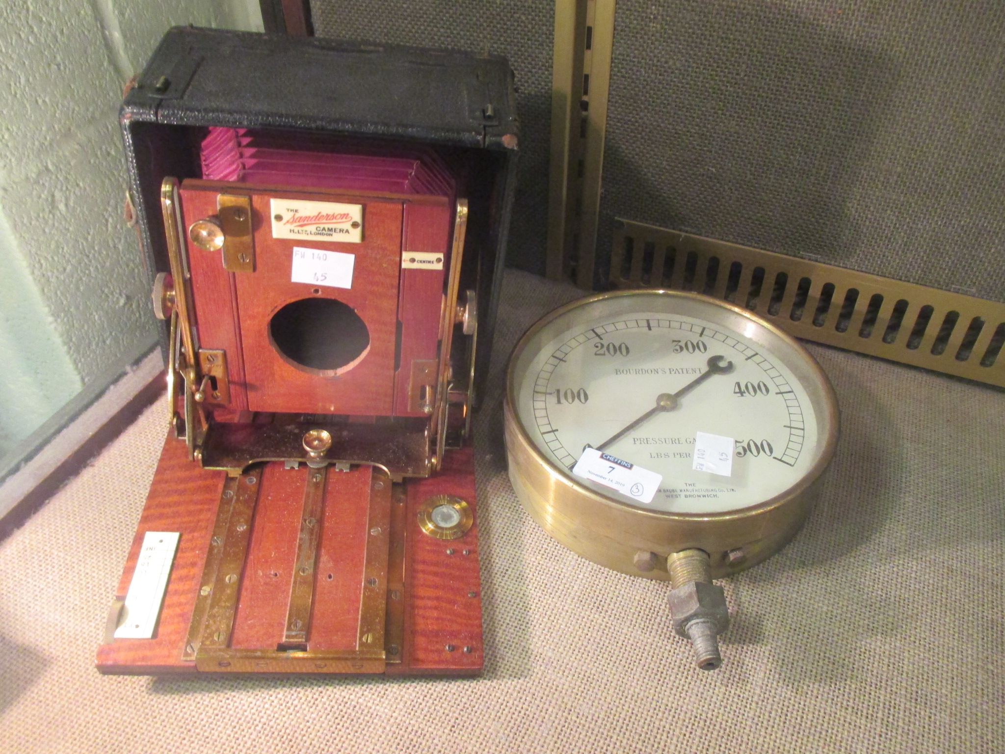 A steam brass pressure gauge, and a Sanderson camera (lacking lens) (2)
