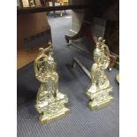 A pair of brass andirons