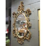 A pair of 18th century style rococo wall mirrors, 134cm high