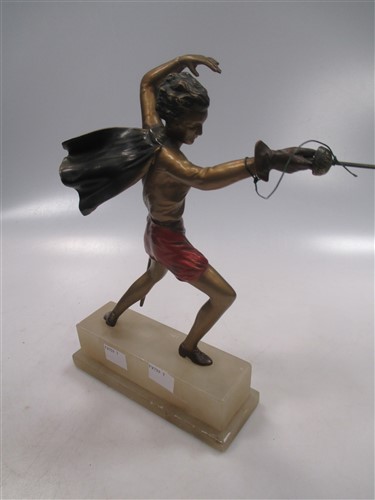 An early 20th century cold painted spelter figure of a fencer with sword and cape