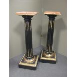 A pair of late 19th century ebonised columns with square marble tops 104cm high (2)