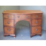 A Regency mahogany bow front dressing table, on ogee bracket feet