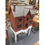 An early 20th century villa style dolls house, with various contents-furnishings including modern