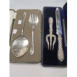 A silver handled bread knife and matching silver bread fork with repoussé decoration, Birmingham
