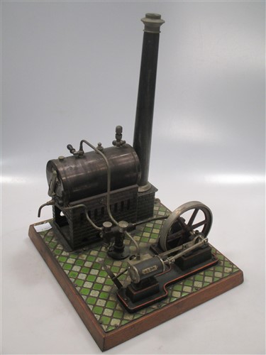 A Bing miniature tinplate Steam stationary engine on a tiled wooden base, with instructions (lacking